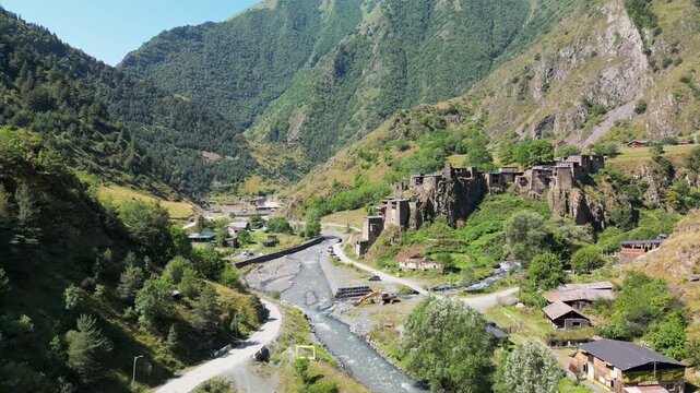 Aerial drone footage of the confluence of two mountain rivers near Shatili, surrounded by steep green slopes and the mountainous landscape of Khevsureti.