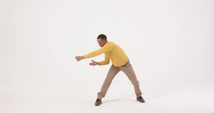 High-speed photography for dynamic scenes, man in yellow sweater dancing energetically, expressing j