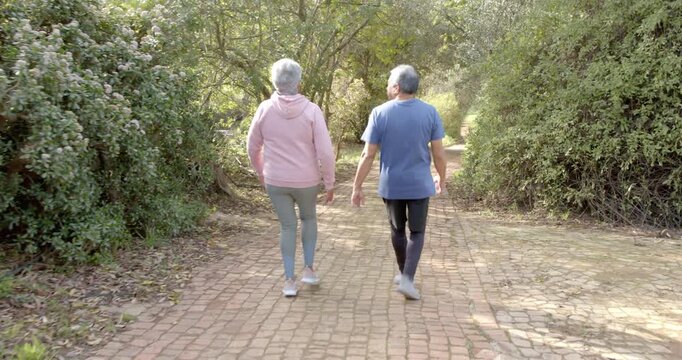 Lifestyle videos outdoor of people doing activities, senior couple holding hands and walking on bric