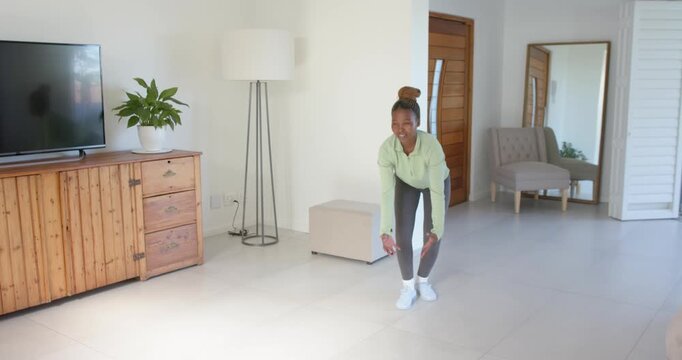 High-speed photography for dynamic scenes, exercising at home, woman doing squats in living room, st