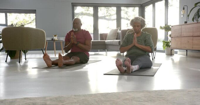 Lifestyle videos indoor of people doing activities at home, stretching on yoga mats, elderly couple