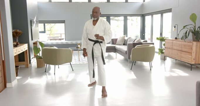 Lifestyle videos indoor of people doing activities at home, practicing martial arts, man in white ka