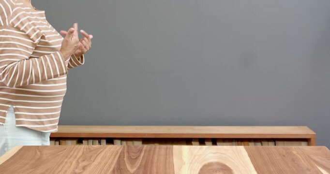 Close up of people talking to the camera, pointing with hand, person in standing by table