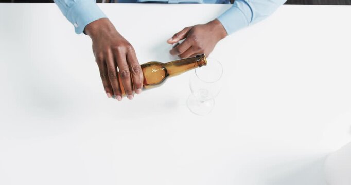 Lifestyle videos indoor of people doing activities at office, pouring beer from bottle into glass, p