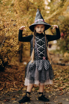 Halloween celebration. A girl dressed as a witch prepared for Halloween.