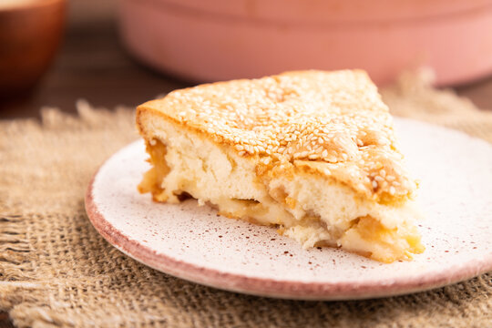 Apple Charlotte cake on brown wooden, side view close up, selective focus