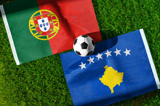 Portugal vs. Kosovo football match. National flags on green grass with soccer ball in the middle. Football background for international match.