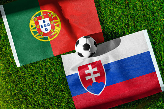 Portugal vs. Slovakia football match. National flags on green grass with soccer ball in the middle. Football background for international match.