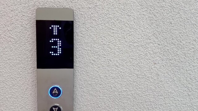 Digital elevator floor indicator showing number three on an interior wall, illustrating vertical transport, building technology, navigation and modern infrastructure.
