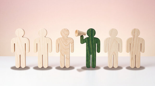 Leadership concept with green wooden figure holding megaphone among neutral figures on white surface