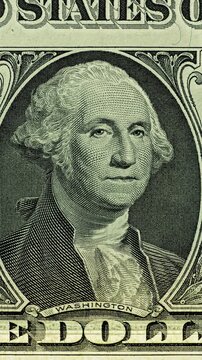 George Washington bill under green security scan. Moving green light sweeps across George Washington bill causing banknote glow. 