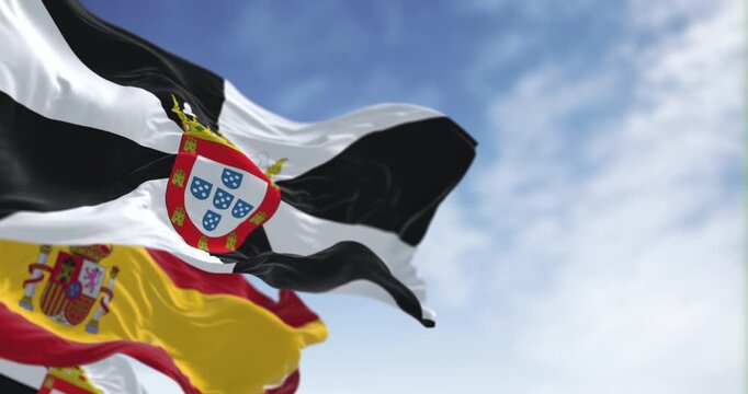 Ceuta and spanish national flags waving on a clear day