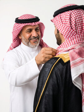 A Proud Father Carefully Adjusts His Son&rsquo;s Shemagh Before a Special Occasion 