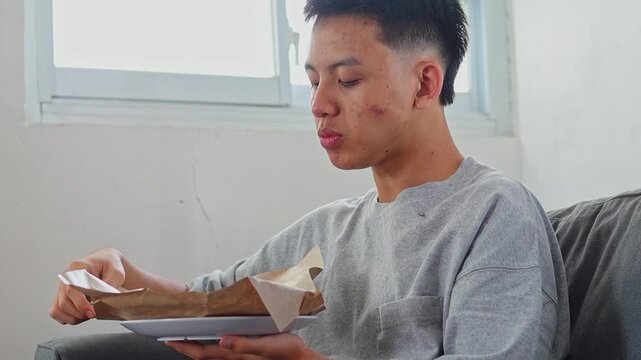 Side view of man eating karedok or traditional indonesian salad served on paper