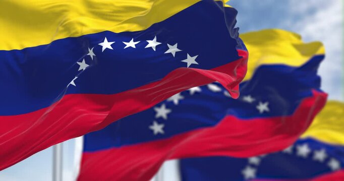 Venezuelan national flag waving in wind against blue sky. 3D render