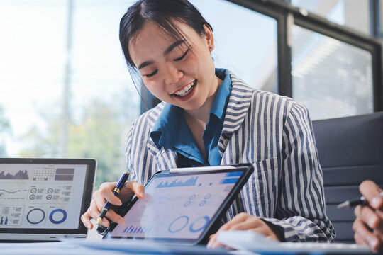 Business professional analyzing financial data on digital tablet dashboard with calculator and laptop, representing accounting software, ERP system integration, performance monitoring.