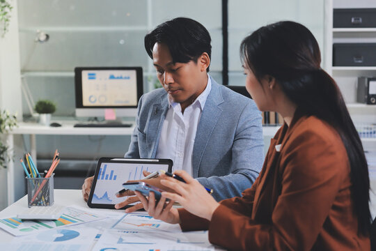 Business professional analyzing financial data on digital tablet dashboard with calculator and laptop, representing accounting software, ERP system integration, performance monitoring.