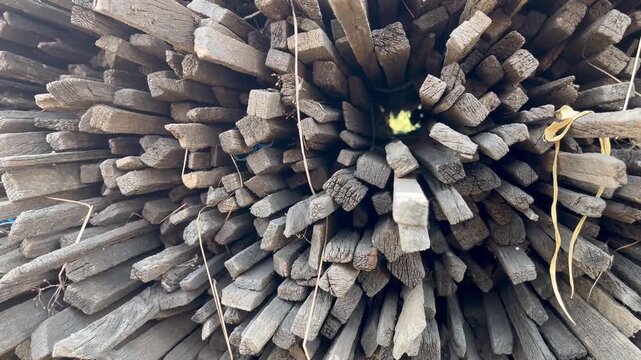 Traditional firewood supply stacked in rural village