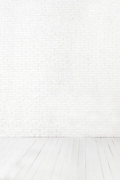 Minimalist white brick wall and wooden floor interior background with white neutral tones, clean empty space, Scandinavian style, modern studio setting, natural light and copy space