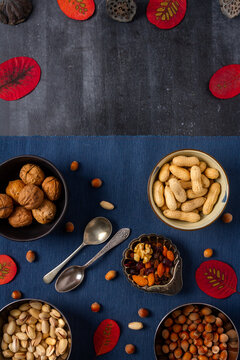 Food themed still life with crockery, various nuts and tea