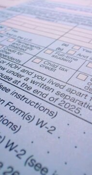 Federal 1040 return form details. USA tax form 1040 fills frame as federal return document. Printed fields numbers and selection boxes suggest careful tax filing preparation.