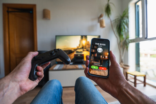 Person taking sick day playing video game with boss calling