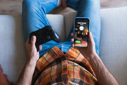 Employee playing video games ignoring boss calling