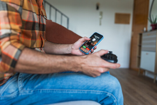 Man receiving boss call during sick day gaming