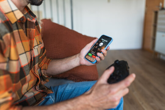 Man playing video games ignoring boss call