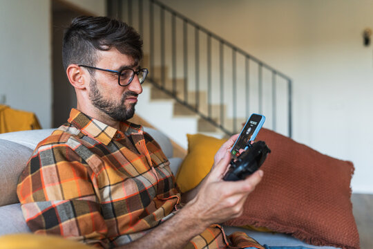 Man avoiding boss call while gaming on a sick day