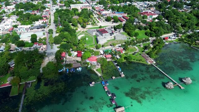 Historic stone fortress and surrounding town border crystal-clear aquamarine shallows.