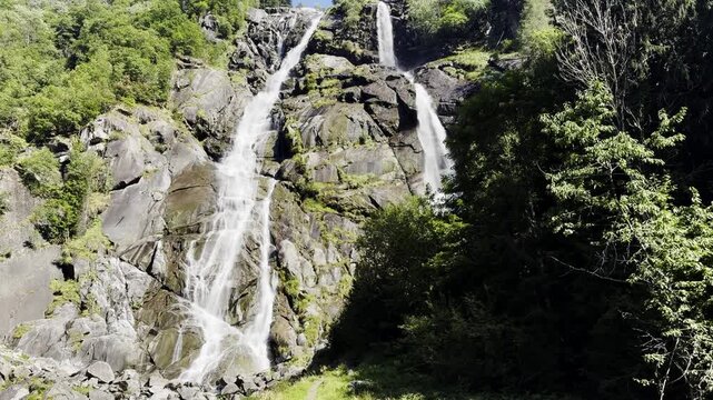 Scenic view of the nardis waterfalls flowing over rocks in the adamello brenta nature park. Beautiful mountain landscape in trentino, italy