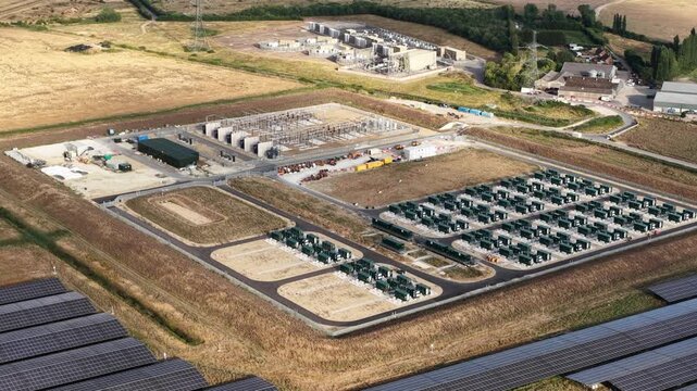 Aerial drone view of Cleve Hill Solar Park near Faversham, Kent, showing large-scale renewable electricity generation, battery storage and modern solar infrastructure.