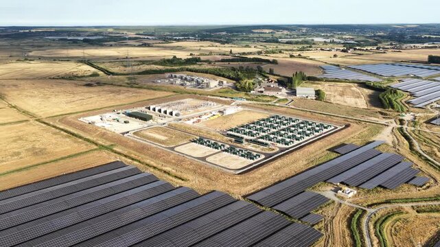 Aerial drone view of Cleve Hill Solar Park near Faversham, Kent, showing large-scale renewable electricity generation, battery storage and modern solar infrastructure.