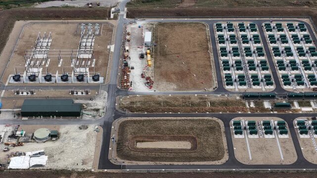 Aerial drone view of Cleve Hill Solar Park near Faversham, Kent, showing large-scale renewable electricity generation, battery storage and modern solar infrastructure.