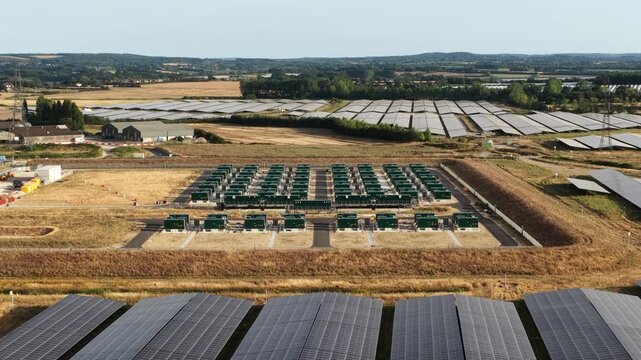 Aerial drone view of Cleve Hill Solar Park near Faversham, Kent, showing large-scale renewable electricity generation, battery storage and modern solar infrastructure.