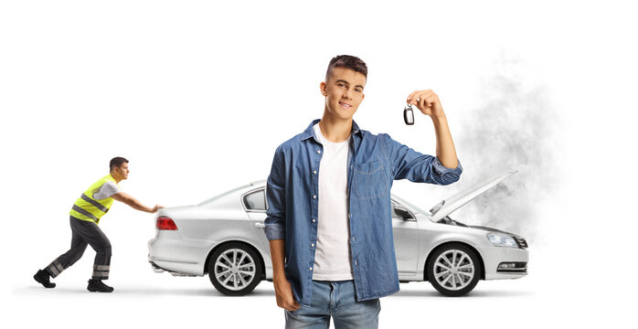 Road assitance worker pushing a broken car and young man holding a car key