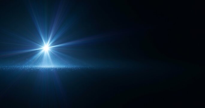 Bright blue light flare on dark background