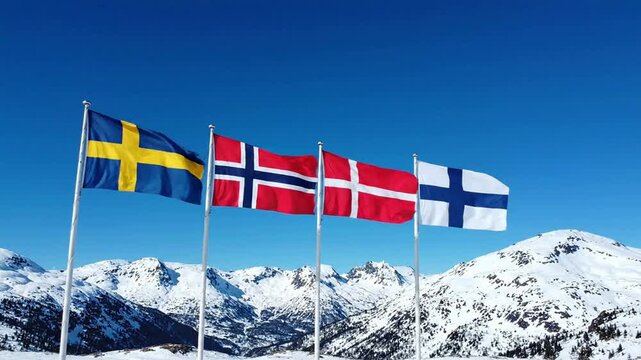 Nordic flags waving together against snowy mountain peaks and clear blue sky scandinavia sweden norway