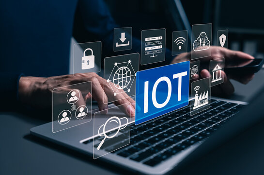 IoT Internet of Things technology concept. User typing on laptop and IoT interface, connected devices, smart networks, cloud computing, cybersecurity, automation, data exchange, digital transformation