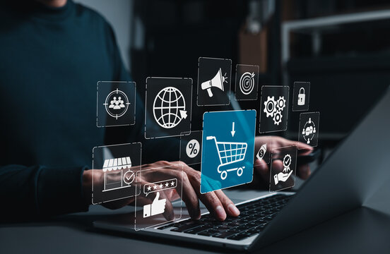 E-commerce digital marketing online shopping cart concept. Customer typing on laptop with icons of shopping trolley, promotion, target audience, percentage discount, storefront, positive rating review