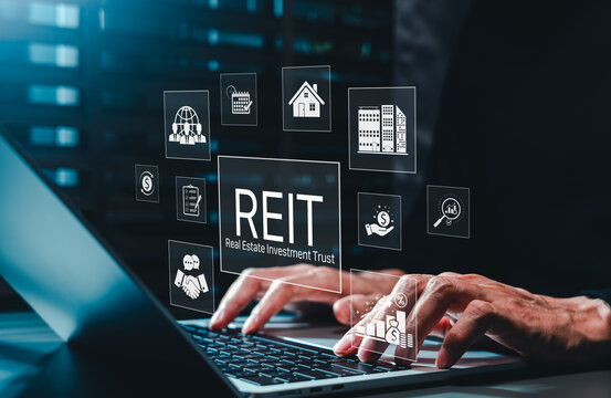 REIT Real Estate Investment Trust finance concept. Investor typing on laptop with icon of residential house, commercial building, property growth, dividend money, global asset, legal contract document