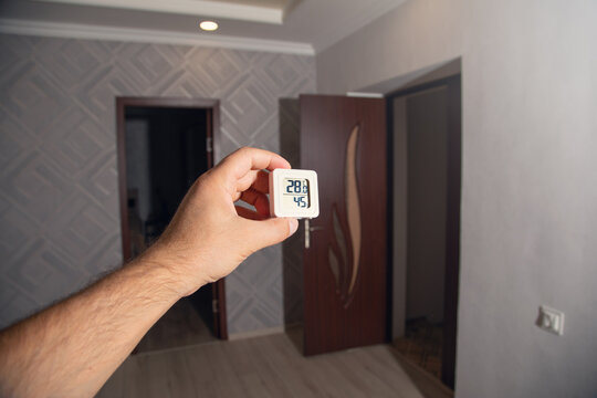 Digital thermostat displaying temperature in home.