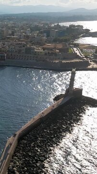 Aerial vertical view of the Old Venetian Port of Chania with breakwater and remains of fortifications, Crete, Greece
