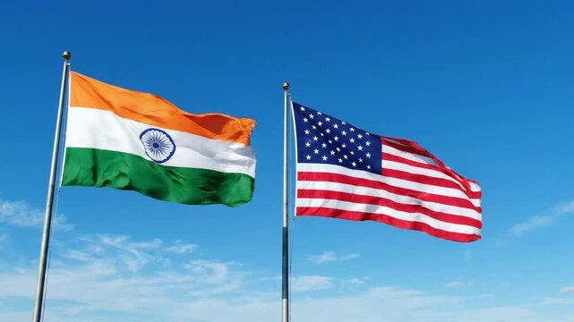 India and usa flags waving together against clear blue sky: symbol of international diplomacy and global partnership