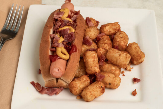 hot dog   and tater tots  top with bacon