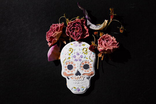 Sugar skull decorated with dried roses for dia de muertos
