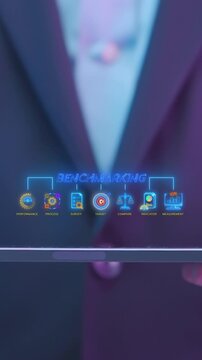 Businessman holding digital tablet vertical shot with glowing benchmarking flowchart metrics. Corporate performance comparison, KPI survey measurement, and business process evaluation idea concept.