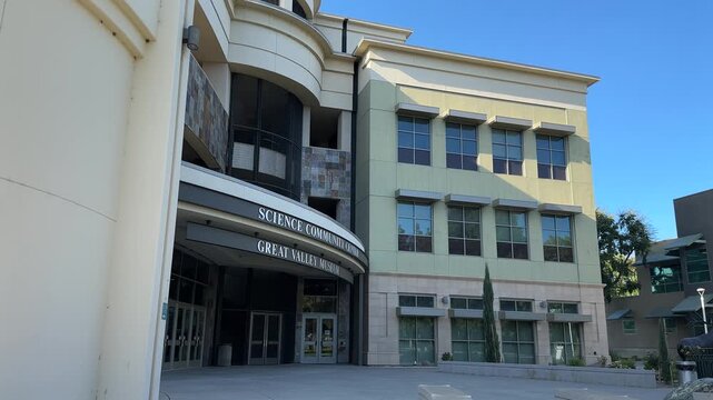 Wide shot of the Great Valley Museum&rsquo;s contemporary exterior at Modesto Junior College. Crisp daylight, sharp shadows, and clear architecture highlight a modern academic setting.