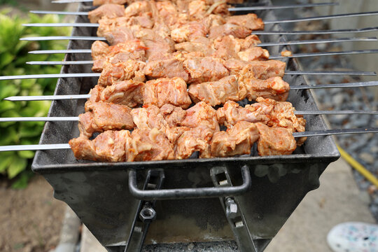 Preparing pork shashlik on the charcoal mangal